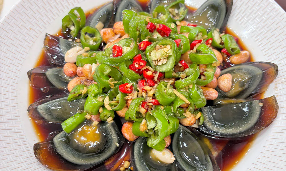 Creamy century egg tossed with spicy green peppers at HuaYuChuan, a Chinese Restaurant in Flushing